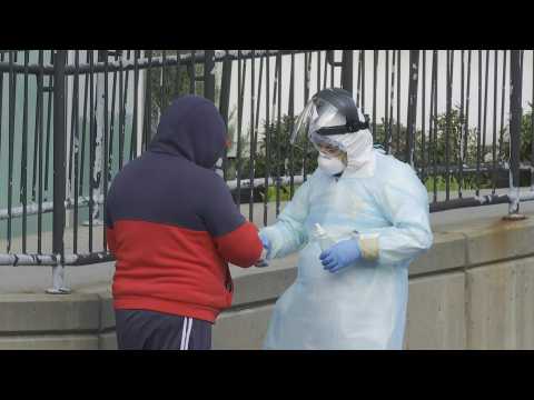 Coronavirus: People line up outside New York hospital to get tested