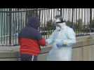 Coronavirus: People line up outside New York hospital to get tested