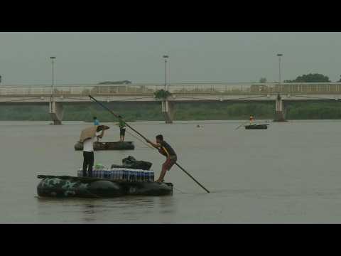 People cross the Suchiate river at Mexico-Guatemala border