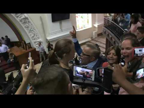 Pro-Guaido lawmakers protest during parliamentary session led by Parra