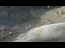 Police hit protesters in Santiago, Chile with water cannons