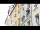 Parisians applaud healthcare workers from their windows