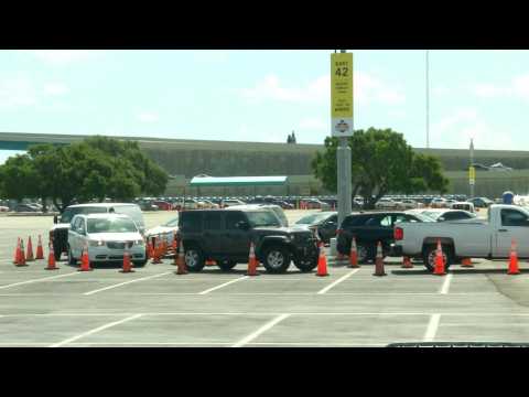 Long line of cars wait at coronavirus drive-through testing site in Miami