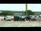 Long line of cars wait at coronavirus drive-through testing site in Miami