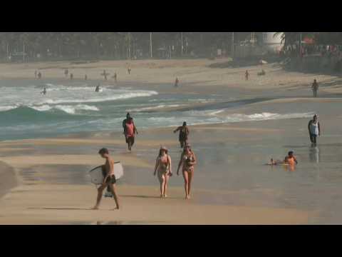Cariocas stroll down Rio beach as city eases virus stay-at-home order