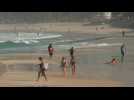 Cariocas stroll down Rio beach as city eases virus stay-at-home order