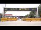 People wait at Delhi station as railways resume some operations