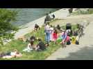 Parisians enjoy a stroll on the banks of the Seine River