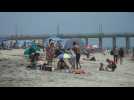 California locals sunbathe and enjoy the water at Huntington Beach on Memorial Day