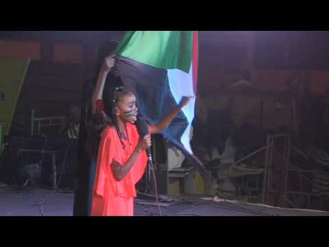 Sudanese protesters gather outside the army's HQ at night