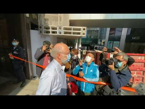 American arrested in Hong Kong on security charge escorted by police