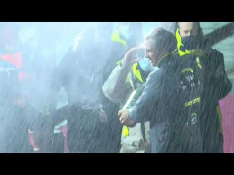 Sailing: Charlie Dalin sprays champagne after crossing finish line first