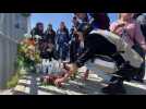 People lay flowers for migrants who died in Mexico detention centre fire