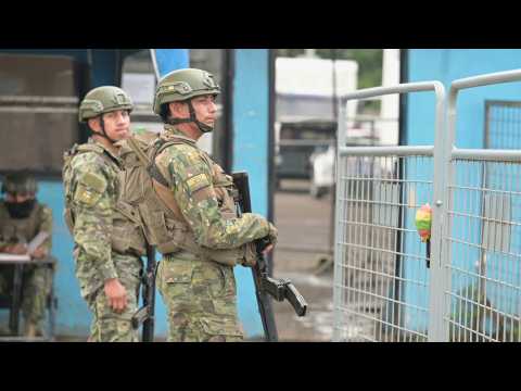 Security guard outside Ecuador prison where six inmates found dead
