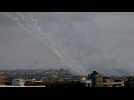Smoke billows and barrage of rockets fired from Gaza towards Israel