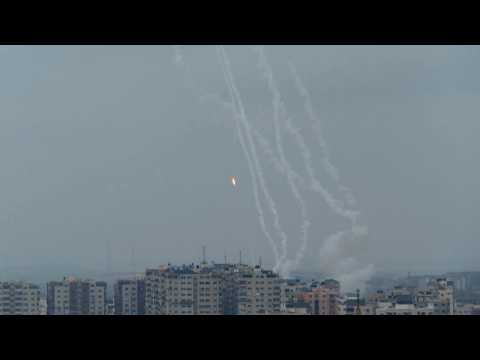 Smoke rises and rockets fired from Gaza Strip into Israel