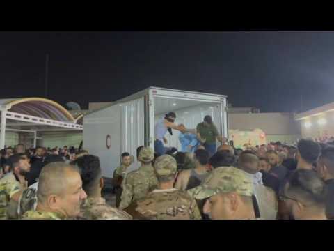People gather outside hospital after 100 killed in Iraqi wedding fire