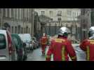 Firefighters and police near the collapsed building in Paris