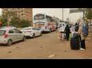 Sudan: People wait to leave Khartoum as smoke rises