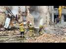 Ukrainian rescuers at scene in Mykolaiv after Russian strike