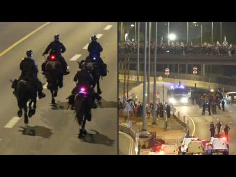 Israeli police use water cannon to disperse protesters blocking Tel Aviv highway