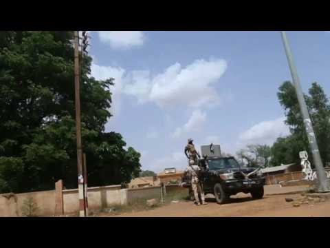 Military outside Niger's national television station and president still detained