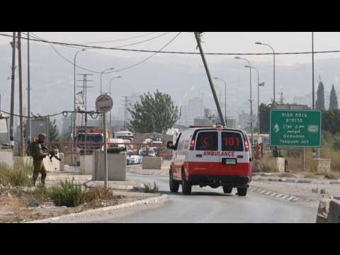 Israeli security forces block a road following a reported attack in the WB