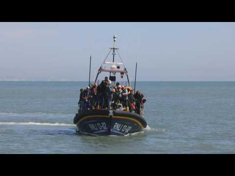 Migrants arrive in Dover after crossing the English Channel by boat