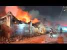 Firefighters tackle a blaze after an explosion in a Dominican shop