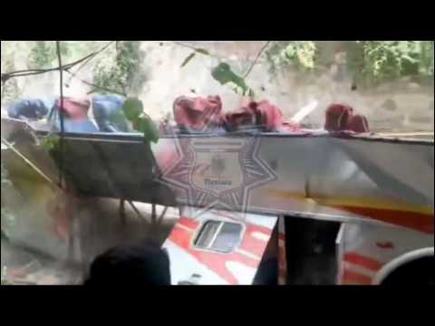 Mexico police and volunteers pull bus back upright after crash kills at least 27