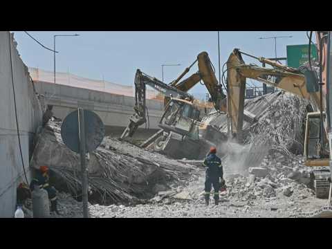 Firefighters search through rubble after bridge collapse in Greece