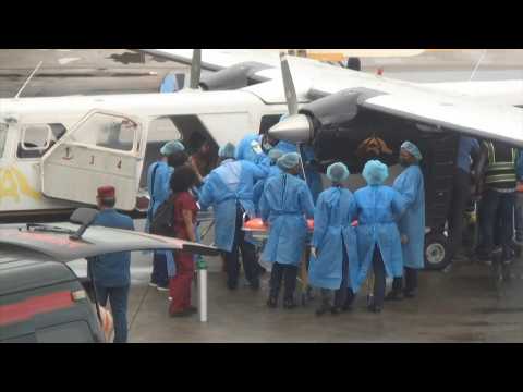 Health workers at Guyana airport treat people injured in school fire