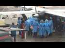 Health workers at Guyana airport treat people injured in school fire