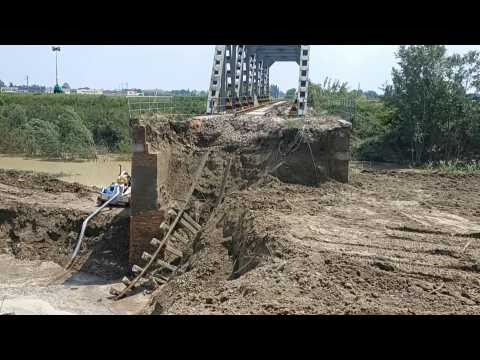 Italy: bulldozers work to repair bridge damaged in the floods