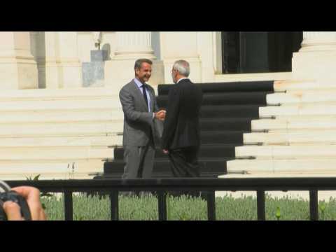Greece's former PM Mitsotakis welcomes interim PM Sarmas at presidential palace