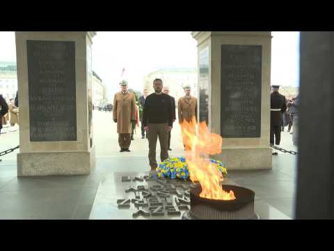 Volodymyr Zelensky lays flowers at the Tomb of the Unknown Soldier in Warsaw