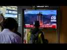 People in Seoul watch the news after North Korean military satellite crashes into sea