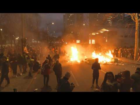 French protesters set dumpsters on fire during march against pension reform