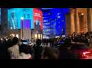 People cheer as exit polls projected onto BBC HQ show Labour landslide in UK election