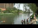 Beijing residents cool off in Liangma River amid searing heatwave