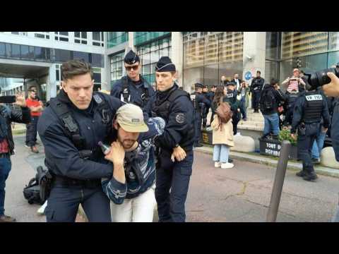 Police remove Extinction Rebellion activists outside Amundi HQ in Paris